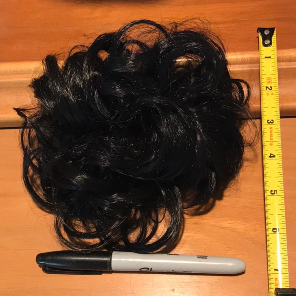 Black hair piece in a round band.